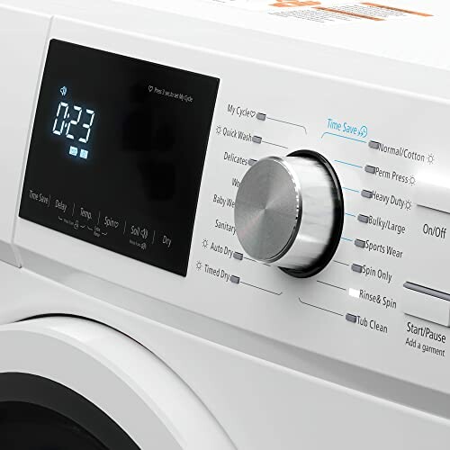 Close-up of a modern washing machine control panel with digital display and settings knob.